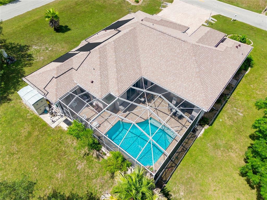 An aerial view of a house with a screened-in pool and a shingled roof — 8206 NIGHTINGALE ROAD, WEEKI WACHEE, FL
