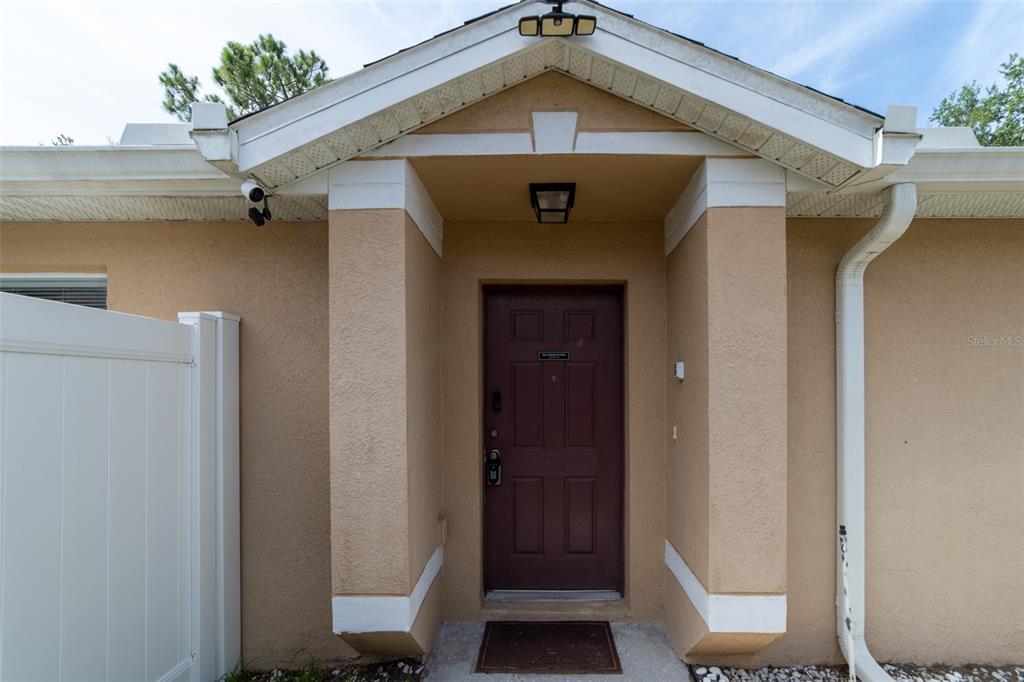An empty dining room features light wood-look flooring, a chandelier, and a large window — 298 HAMMOCK COURT, DAVENPORT, FL