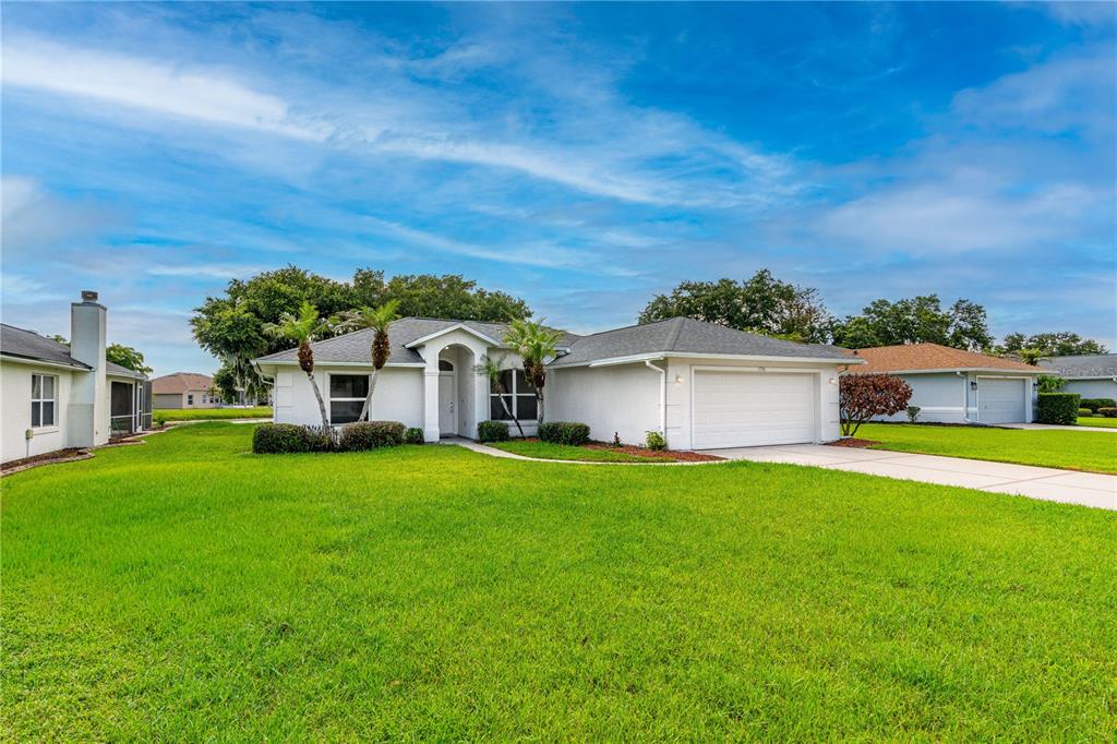 A single-story white house with a two-car garage and a green lawn — 1730 ARASH CIRCLE, PORT ORANGE, FL