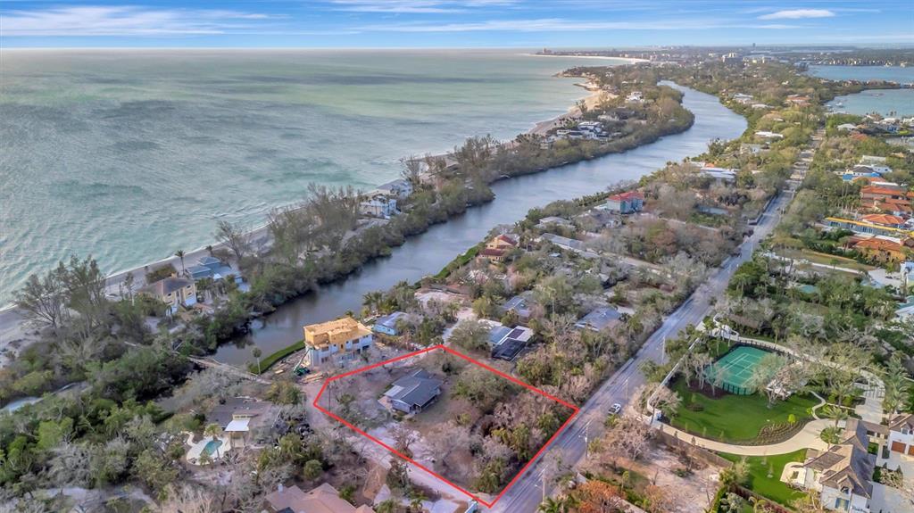 An aerial view shows a house on a lot outlined in red near a waterway — 8555 HERON LAGOON CIRCLE, SARASOTA, FL