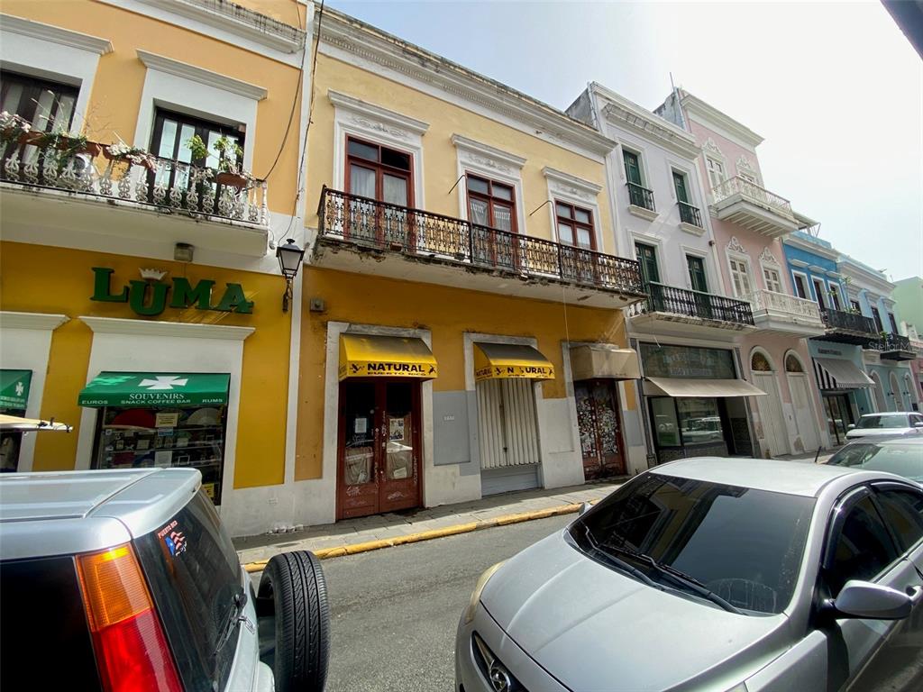 A street-level view of colorful historic buildings with balconies and storefronts in Old San Juan — 257 SAN FRANCISCO, SAN JUAN, PR
