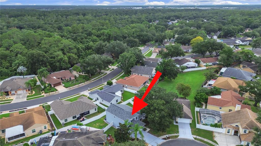 An aerial view shows a two-story house with a grey roof in a suburban neighborhood — 2348 ASAPH COURT, LAND O LAKES, FL