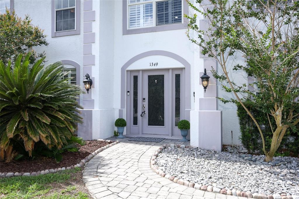 The backyard features a swimming pool, a covered patio, and lounge chairs under an umbrella — 1349 VALLEY PINE CIRCLE, APOPKA, FL