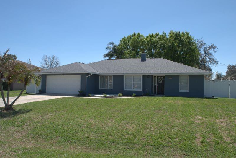 A single-story house with a gray exterior, a two-car garage, and a large front lawn — 3486 HAWKIN DRIVE, KISSIMMEE, FL