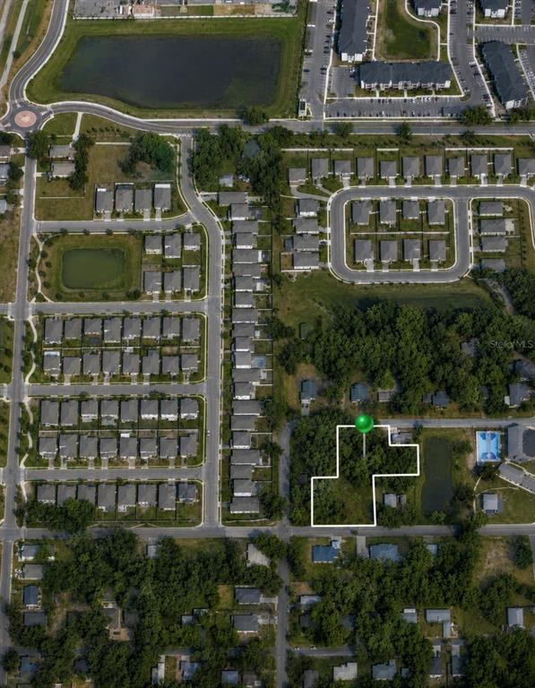This aerial map shows a residential neighborhood with a highlighted vacant lot — 711 PINE, MOUNT DORA, FL