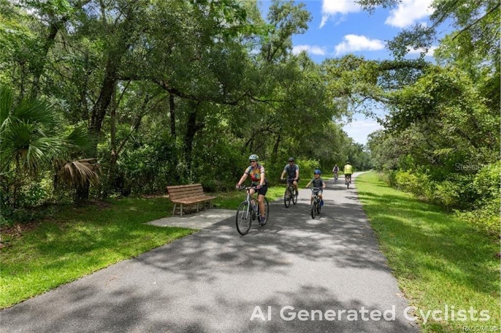 A paved trail winds through a wooded area with a wooden bench and cyclists — 4855 N HIGHLAND PARK DRIVE, HERNANDO, FL