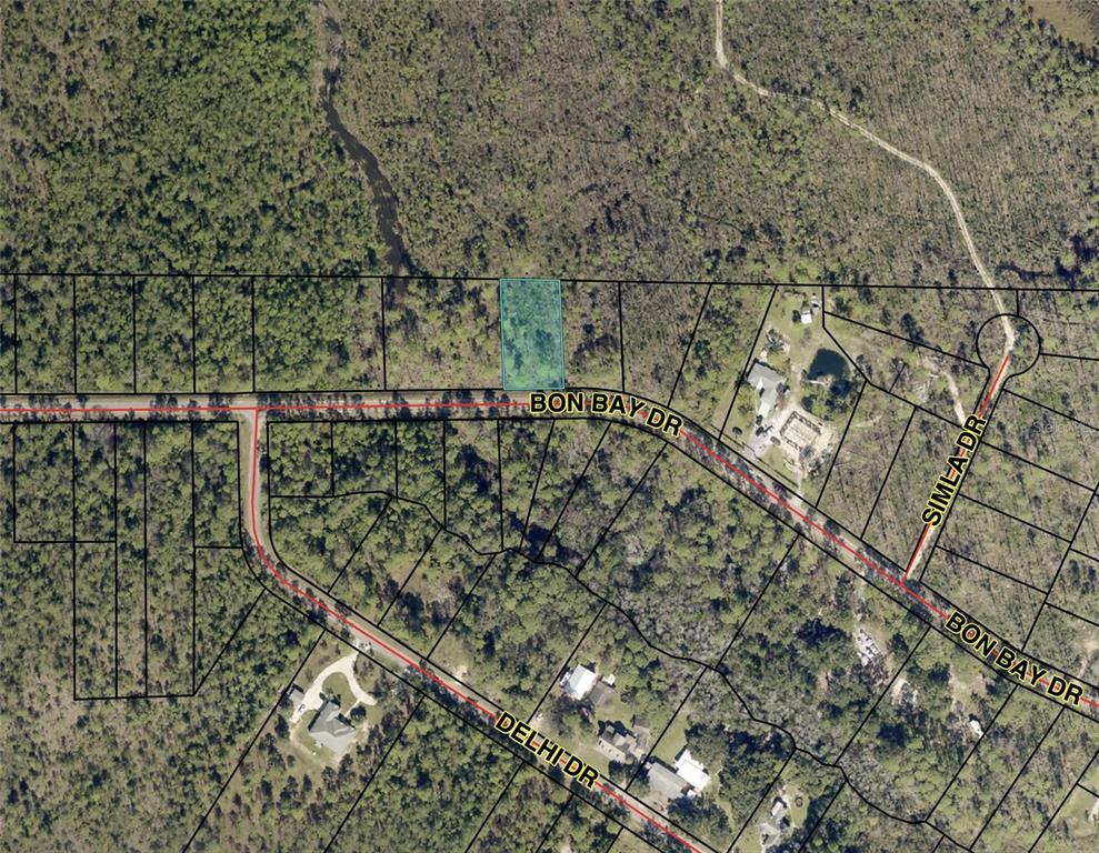 This is an aerial map showing a highlighted vacant lot along a residential street — BON BAY DRIVE, MILTON, FL