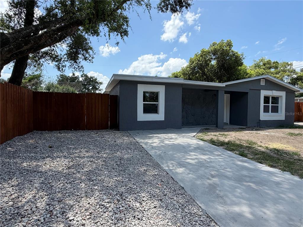 A single-story gray house with a stone accent wall, white trim, and a concrete driveway — 682 DURANGO WAY, ALTAMONTE SPRINGS, FL