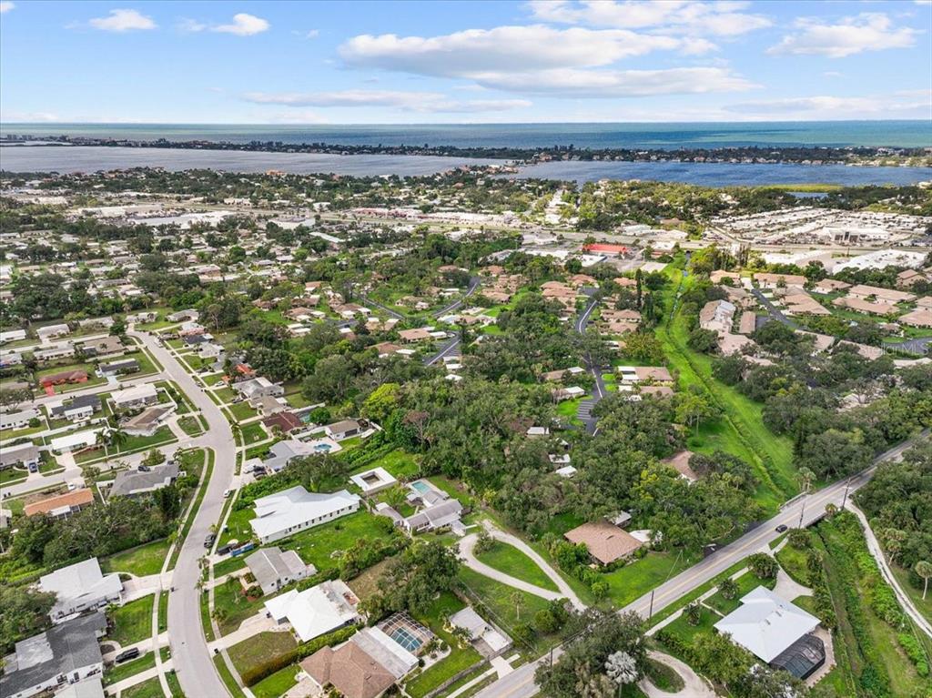 An aerial view shows a house with a circular driveway and pool on a large lot — 2404 BISPHAM ROAD, SARASOTA, FL