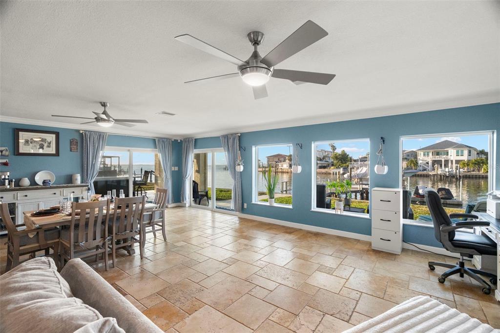A bright dining and office area with tile floors, ceiling fans, and large waterfront windows — 2288 EDYTHE DRIVE, DUNEDIN, FL
