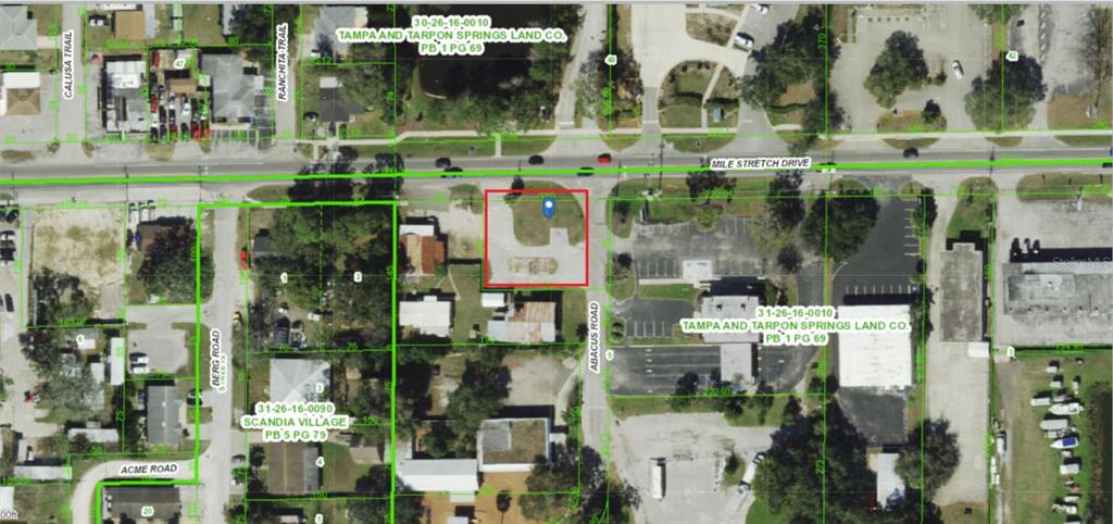 This is an aerial map showing a highlighted vacant lot located at a street intersection — 4650 MILE STRETCH DRIVE, HOLIDAY, FL