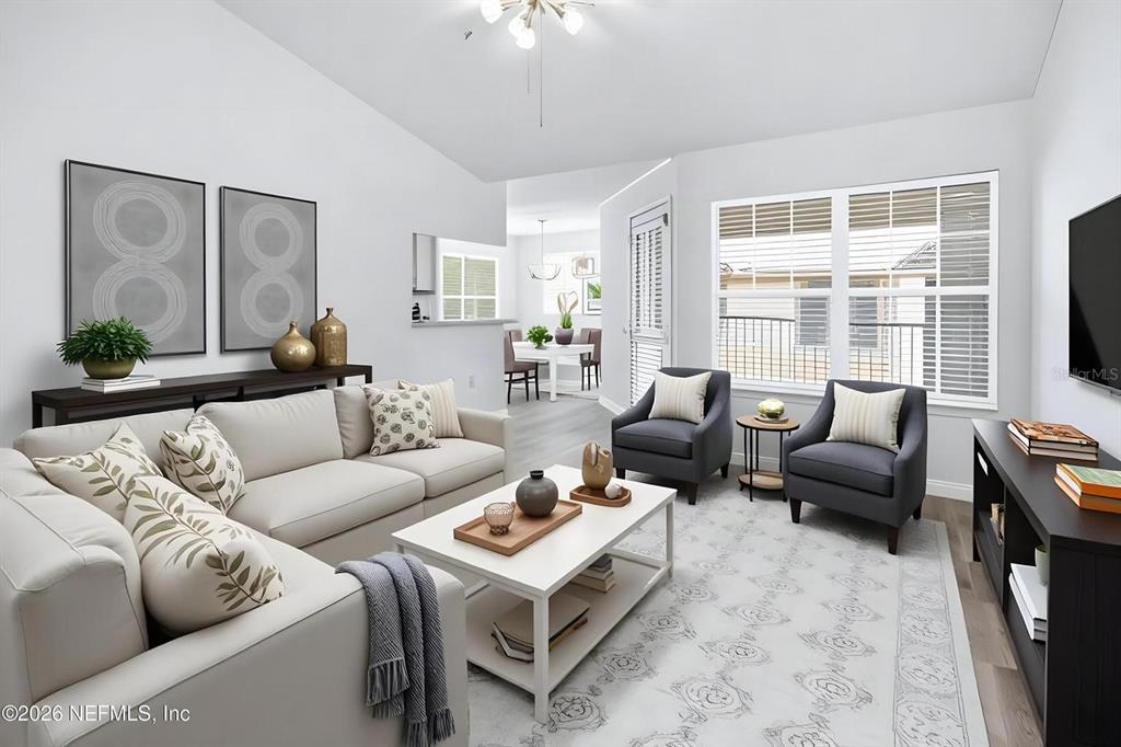 This living room features a white sofa, two gray armchairs, and a central coffee table — 7800 POINT MEADOWS DRIVE UNIT 737, JACKSONVILLE, FL