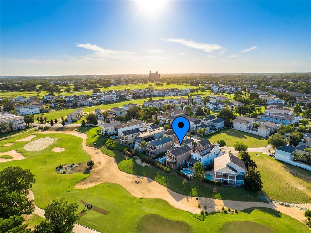 A two-story tan house features a swimming pool, a patio, and a second-floor balcony — 7526 EXCITEMENT DRIVE, REUNION, FL