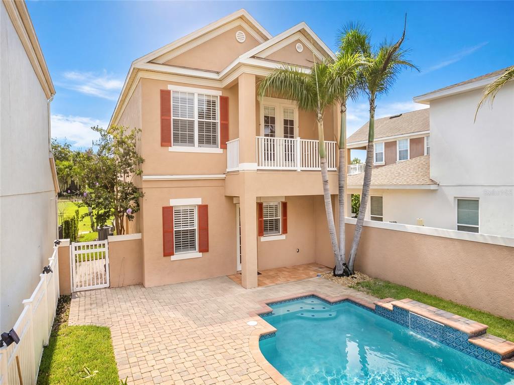 A two-story house with a swimming pool and a waterfall feature in the backyard — 7526 EXCITEMENT DRIVE, REUNION, FL