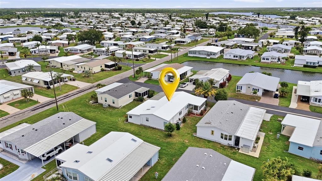An aerial view shows a white manufactured home with a yellow location pin marker — 452 SHARKS POINT, NORTH PORT, FL