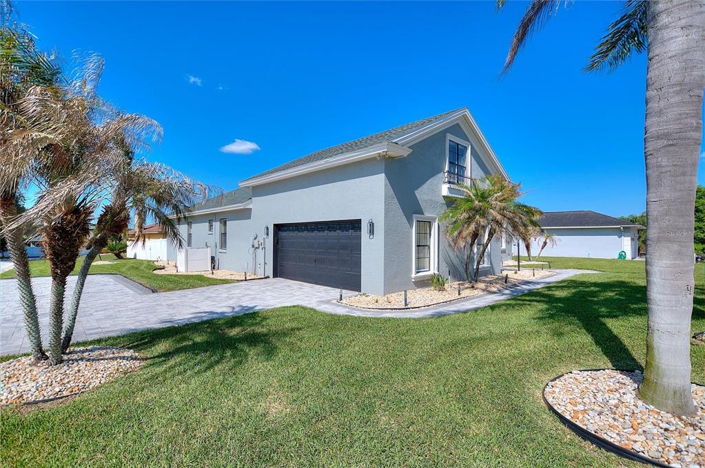 A gray two-story house with a dark garage door and a paved driveway — 2687 BROOKSIDE BLUFF LOOP, LAKELAND, FL