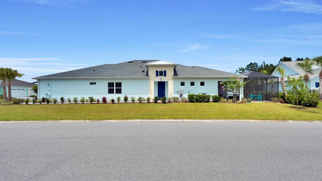 A light blue single-story house with a dark roof and a screened-in back patio — 202 SUMMERTIME PLACE, DAYTONA BEACH, FL