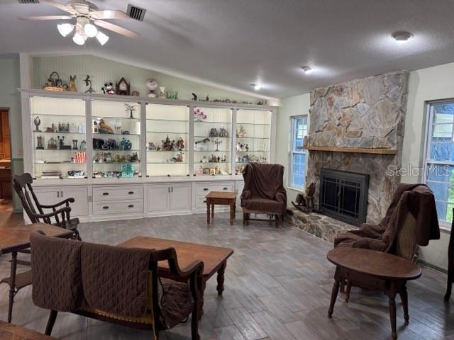 A living room features a large built-in display cabinet, a stone fireplace, and tile flooring — 1121 OLD POLK CITY ROAD, LAKELAND, FL