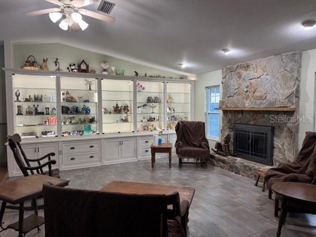 A living room features a large stone fireplace, built-in display shelving, and tile flooring — 1121 OLD POLK CITY ROAD, LAKELAND, FL