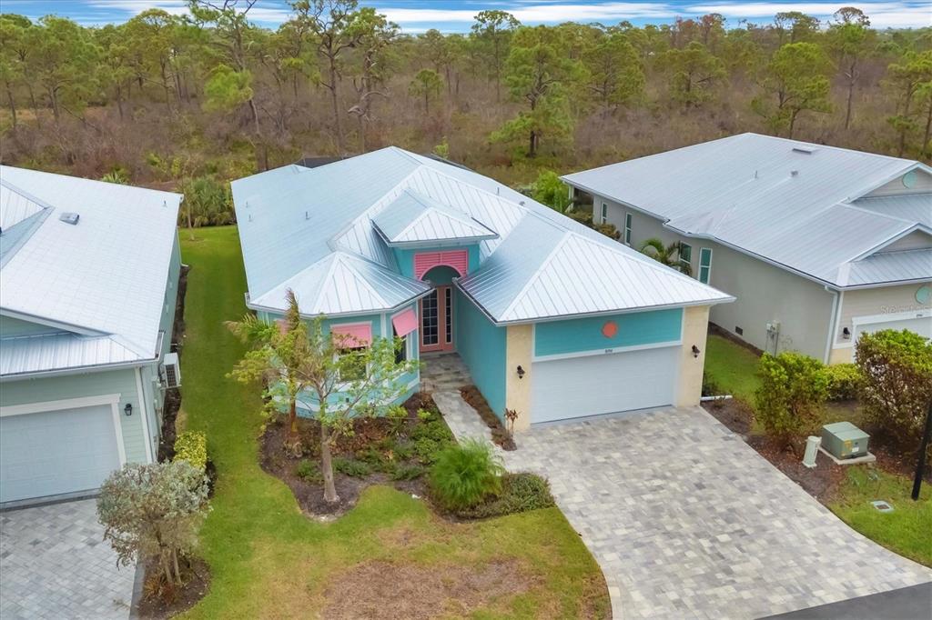 An aerial view of a turquoise house with a metal roof and a paved driveway — 8936 SCALLOP WAY, PLACIDA, FL