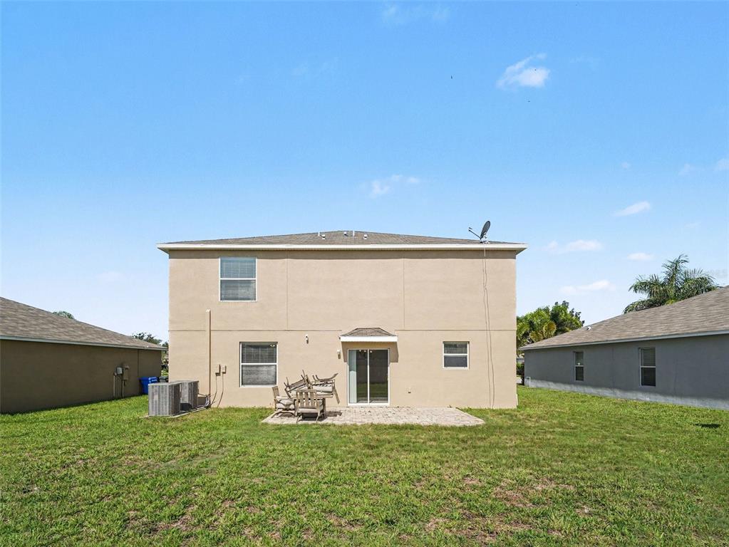A living room with a sectional sofa, television, and dining area in an open floor plan — 2210 PURPLE ORCHID PLACE, RUSKIN, FL