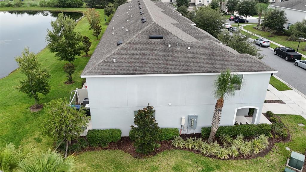 A two-story townhouse with a gray stucco exterior, a one-car garage, and a concrete driveway — 2163 CRYSTAL BELL STREET, ORLANDO, FL