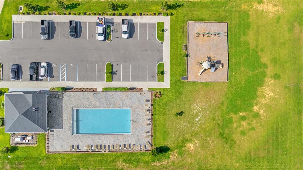 An aerial view shows a swimming pool, a playground, and a parking lot — 38465 HONEYSUCKLE DRIVE, DADE CITY, FL
