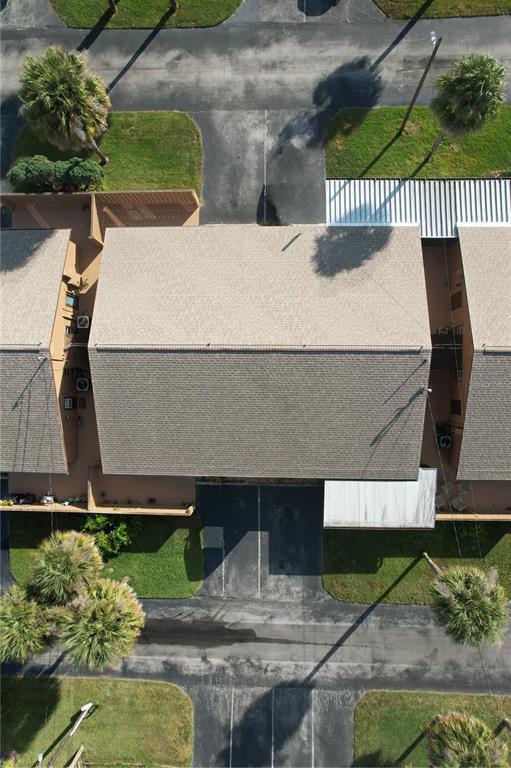 An aerial view shows a residential building with a shingled roof and surrounding parking areas — 474 C STREET, CASSELBERRY, FL