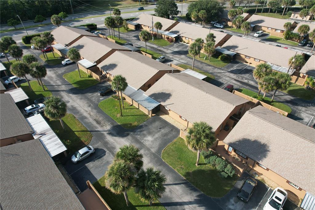 An aerial view shows a residential complex with multiple single-story buildings and palm trees — 474 C STREET, CASSELBERRY, FL