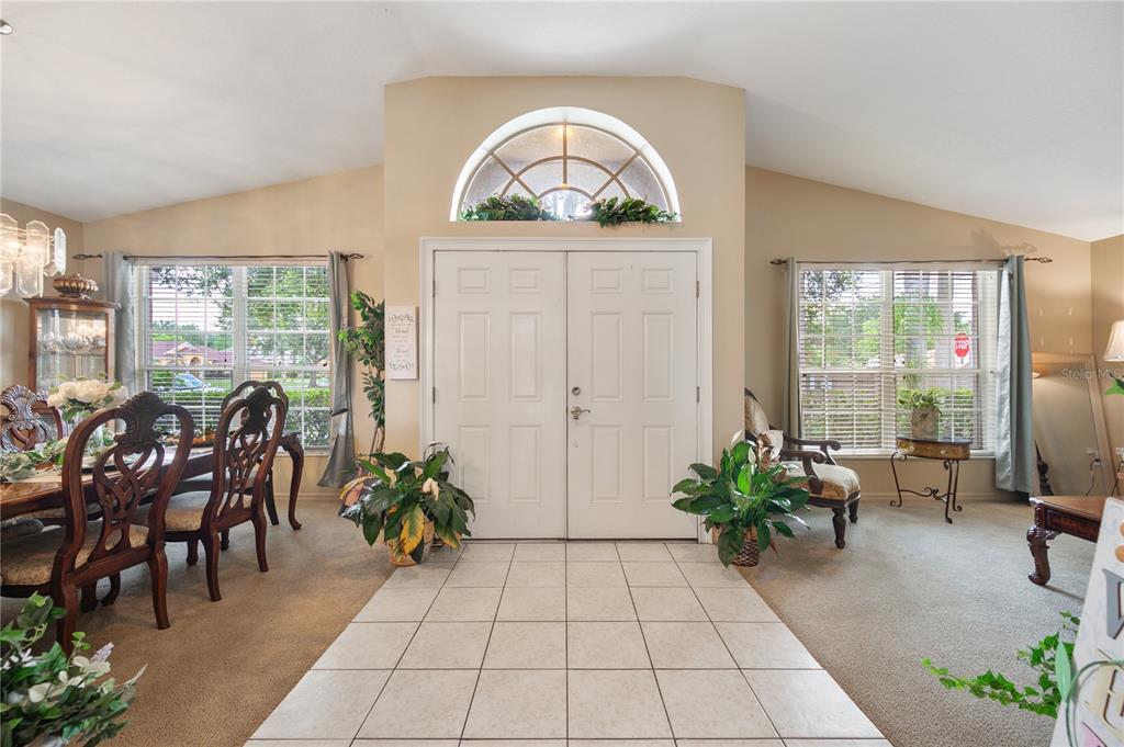A tiled entryway features double front doors with a large arched window above — 101 KIANA DRIVE, BRANDON, FL