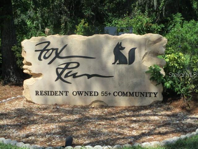 A stone sign for Fox Run, a resident-owned 55+ community, sits in a landscaped area — 3224 MANATEE ROAD, TAVARES, FL
