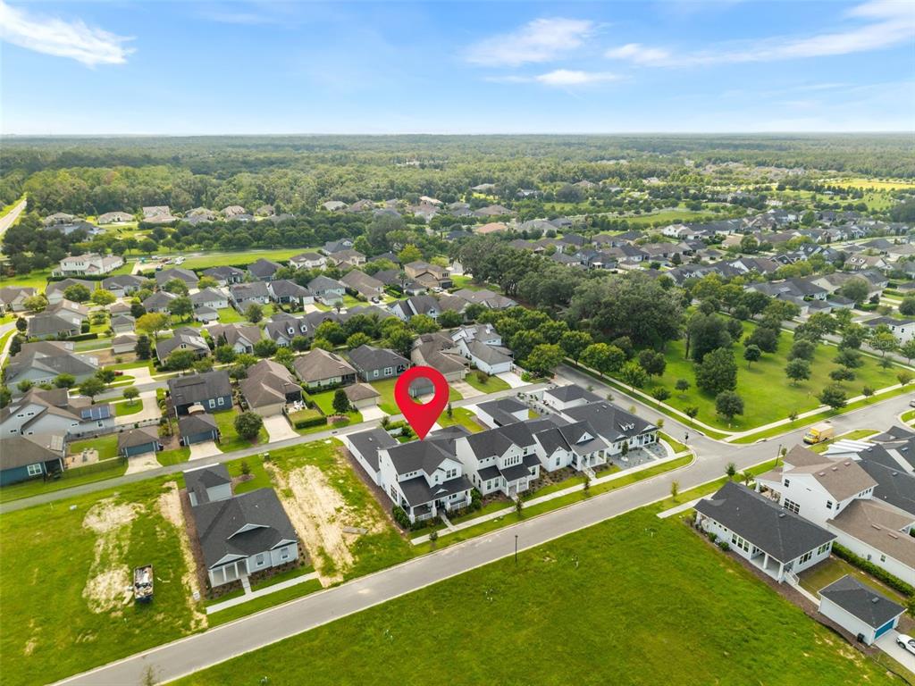 An aerial view shows a residential neighborhood with a red pin marking a townhome unit — 2509 SW 120TH DRIVE, GAINESVILLE, FL