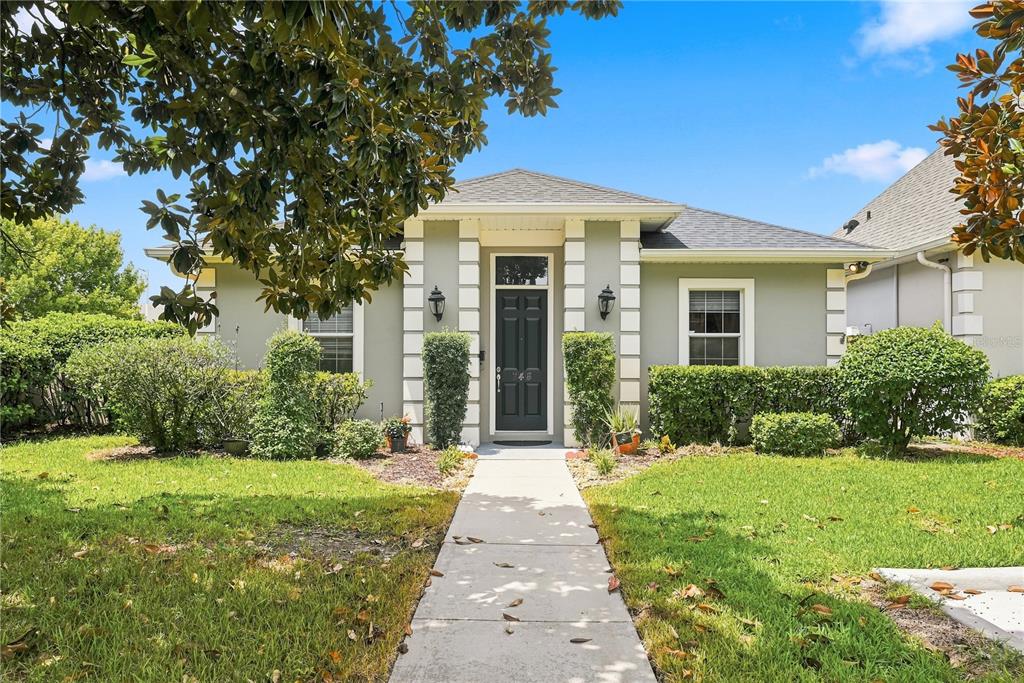 A single-story house with a light green exterior, white corner accents, and a dark front door — 746 COUNTRY LANE, ORLANDO, FL