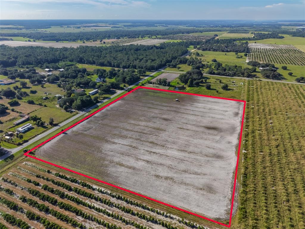 An aerial view shows a large, rectangular plot of cleared land outlined in red — DOC LINDSEY ROAD, FORT MEADE, FL
