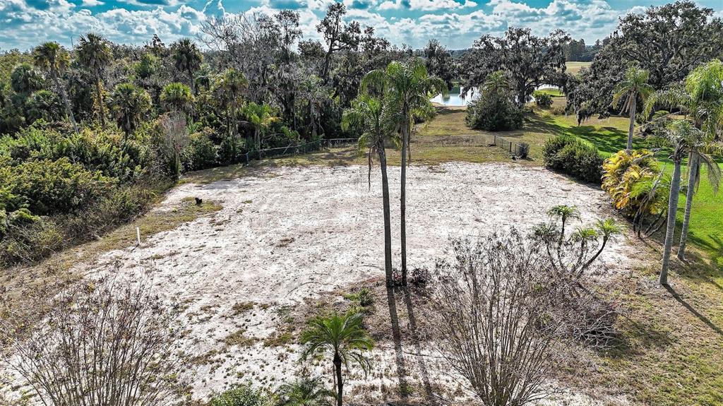 An elevated view of a cleared, sandy residential lot surrounded by trees and palm trees — 3001 WILDERNESS BOULEVARD E, PARRISH, FL