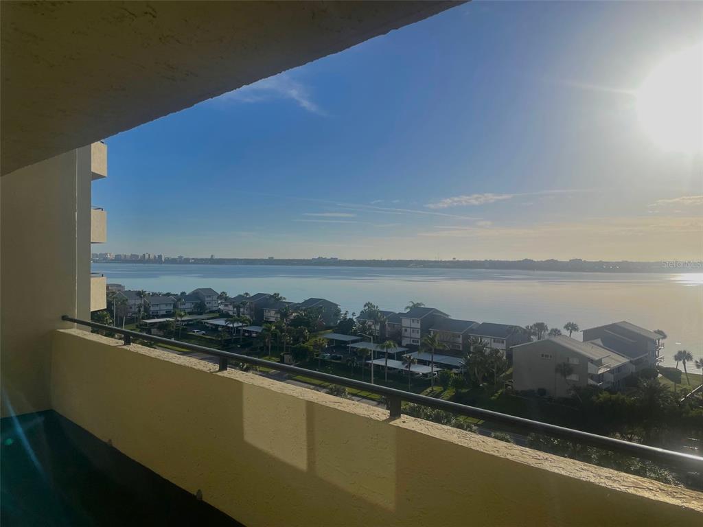 A view from a balcony overlooking a body of water and residential buildings — 1290 GULF BOULEVARD UNIT 901, CLEARWATER, FL