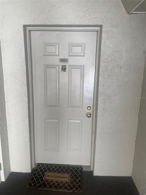 A white front door with the number 901 and a welcome mat on the floor — 1290 GULF BOULEVARD UNIT 901, CLEARWATER, FL