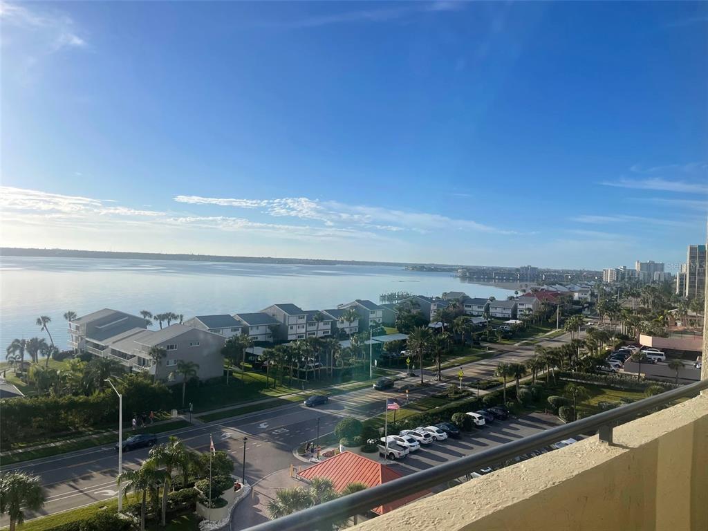 A high-angle view of a coastal road, residential buildings, and a large body of water — 1290 GULF BOULEVARD UNIT 901, CLEARWATER, FL