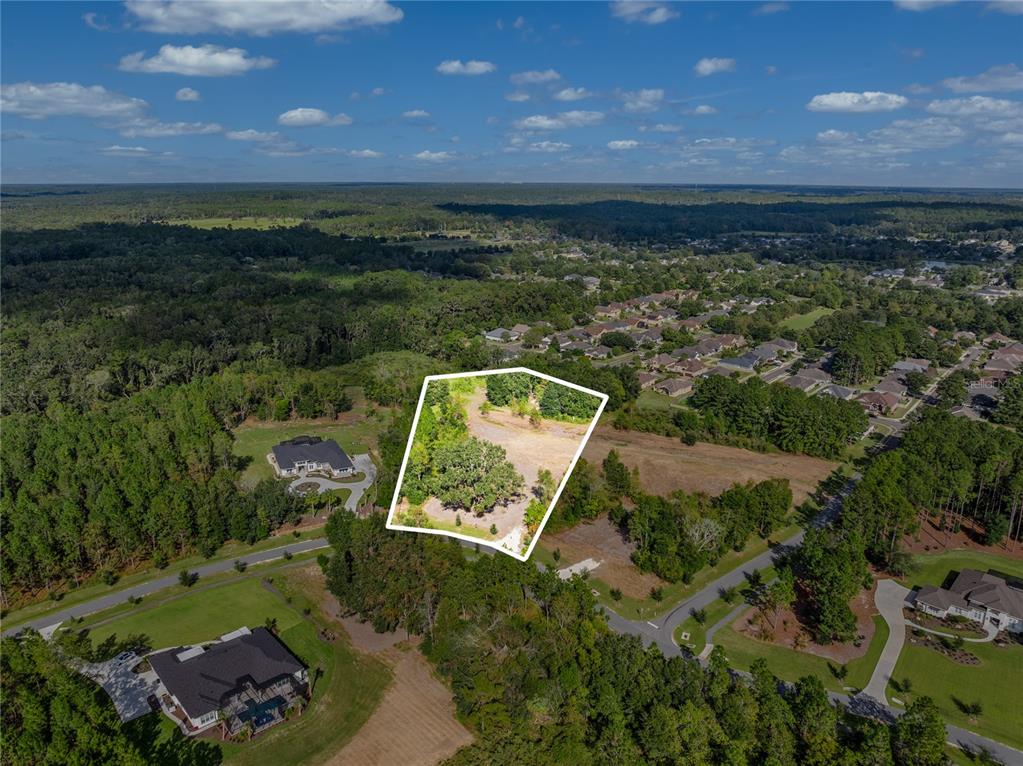 An aerial view shows a vacant, partially wooded residential lot outlined in white — 2527 NW 150TH BOULEVARD, NEWBERRY, FL