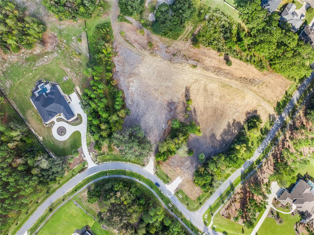 An aerial view shows a large vacant lot next to a house and a road — 2527 NW 150TH BOULEVARD, NEWBERRY, FL