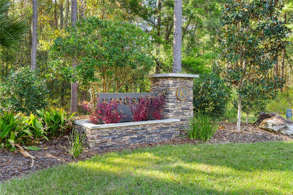 A stone monument sign with the name Kingston sits in a landscaped area with trees — 2527 NW 150TH BOULEVARD, NEWBERRY, FL