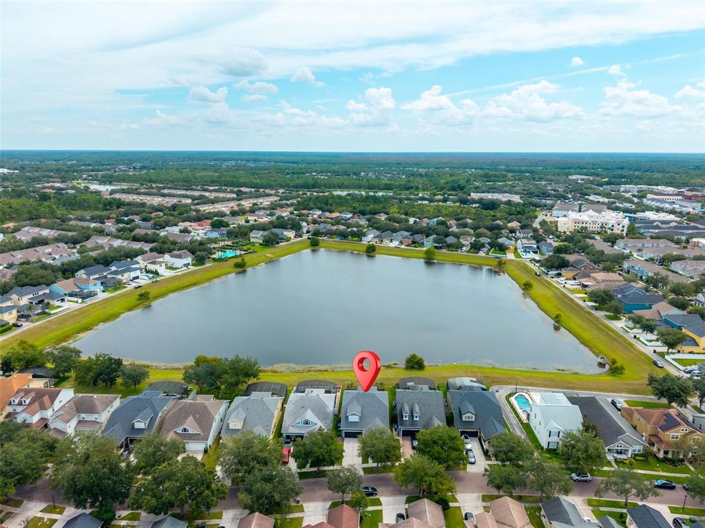 An aerial view shows a house with a red location pin overlooking a large lake — 13356 PHOENIX DRIVE, ORLANDO, FL