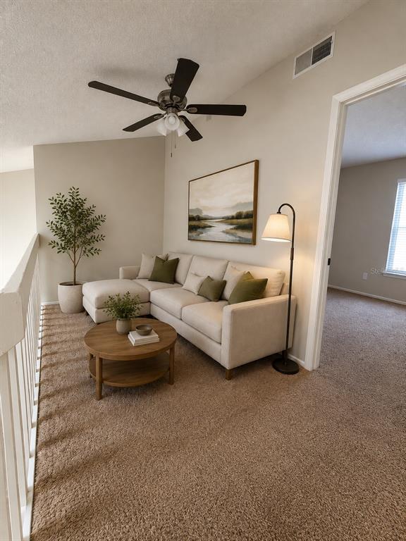 A carpeted loft area features a sectional sofa, a round coffee table, and a ceiling fan — 2760 GRAY FOX LANE, ORLANDO, FL