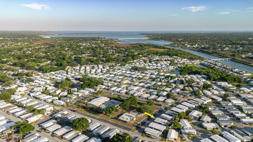 An aerial view shows a dense residential community with a yellow arrow pointing to a home — 372 COBIA WAY, OLDSMAR, FL