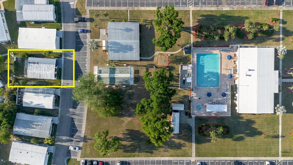 An aerial view shows a mobile home highlighted in yellow next to a community pool — 372 COBIA WAY, OLDSMAR, FL