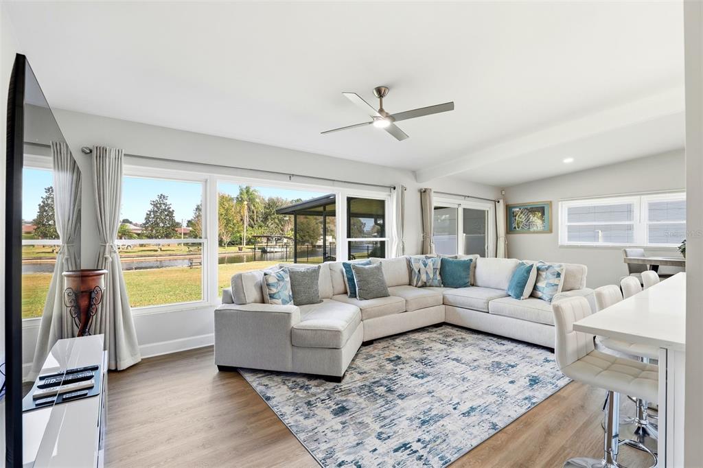 A view from an entryway looking into a living room with light wood-look flooring — 2705 GULFSTREAM ROAD, ORLANDO, FL