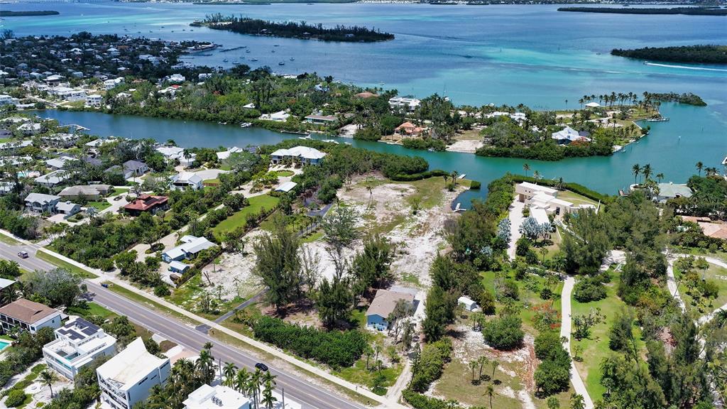 An aerial view shows a coastal property with a large vacant lot near the water — 6660 & 6664 & 6670 GULF OF MEXICO DRIVE, LONGBOAT KEY, FL
