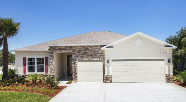 A single-story house with a stone facade, two-car garage, and a palm tree in front — 1630 NUREMBURG BOULEVARD, PUNTA GORDA, FL