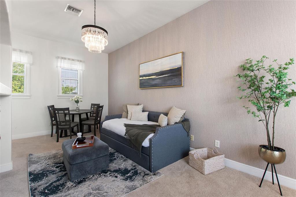 A room features a daybed, a small dining set, a chandelier, and a potted plant — 1524 EUSTON DR, KISSIMMEE, FL