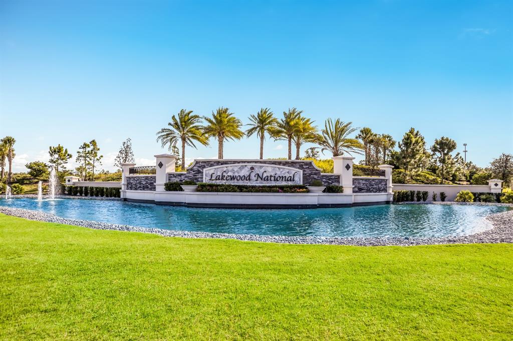 The entrance sign for Lakewood National sits behind a pond with fountains and palm trees — 5721 PALMER CIRCLE UNIT 201, BRADENTON, FL